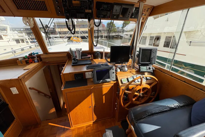 Slide: The Image of 1984 Grand Banks Classic yacht helm with navigation equipment and wooden steering wheel. - 30