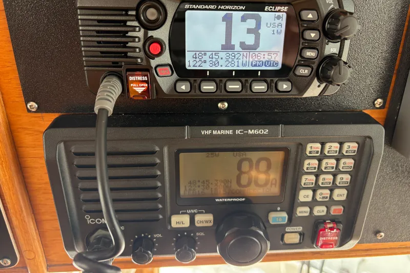 Slide: The Image of VHF marine radios on 1984 Grand Banks Classic boat, displaying coordinates and channel information. - 37