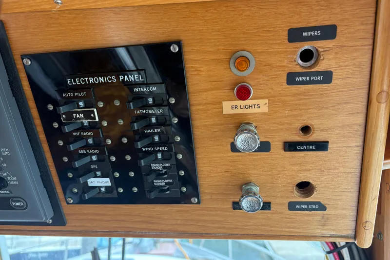 Slide: The Image of 1984 Grand Banks Classic electronics panel with switches and controls for navigation and communication. - 38