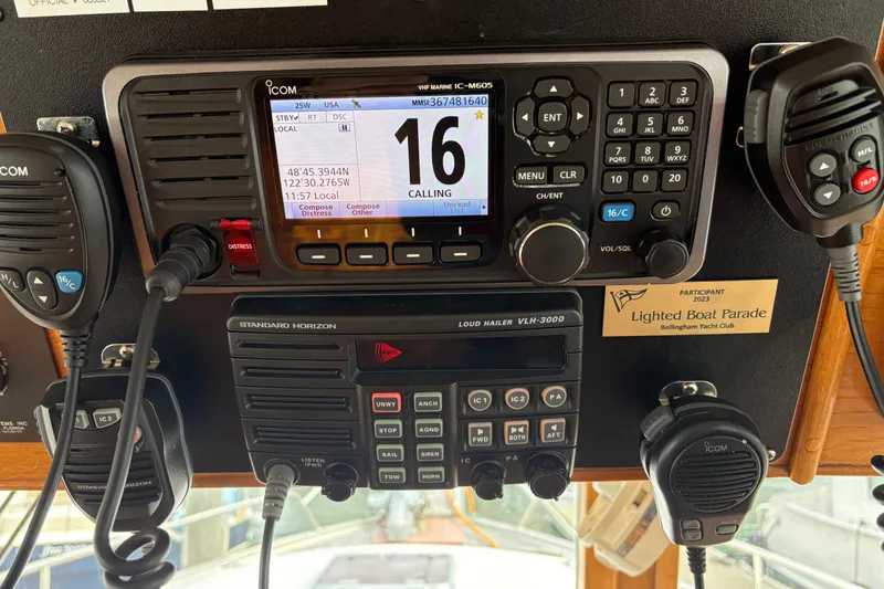 Slide: The Image of VHF radio equipment on 1984 Grand Banks Classic, featuring Icom and Standard Horizon devices. - 40