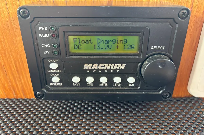 Slide: The Image of Magnum Energy control panel displaying float charging status on a 1984 Grand Banks Classic. - 42