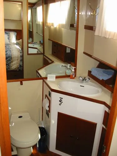 Slide: The Image of 1984 Grand Banks Classic yacht bathroom with sink, toilet, and mirror. - 45