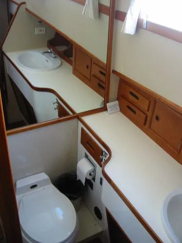Slide: The Image of 1984 Grand Banks Classic yacht bathroom with sink, mirror, and wooden cabinetry. - 46