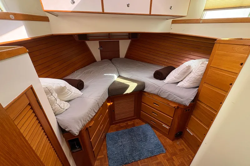 Slide: The Image of Cozy cabin interior of 1984 Grand Banks Classic yacht with twin beds and wooden furnishings. - 48