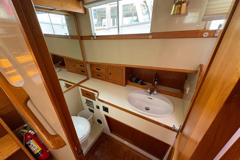 Slide: The Image of 1984 Grand Banks Classic yacht bathroom with wooden cabinetry and modern fixtures. - 49
