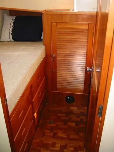 Slide: The Image of 1984 Grand Banks Classic cabin interior with wooden cabinetry and bed. - 51