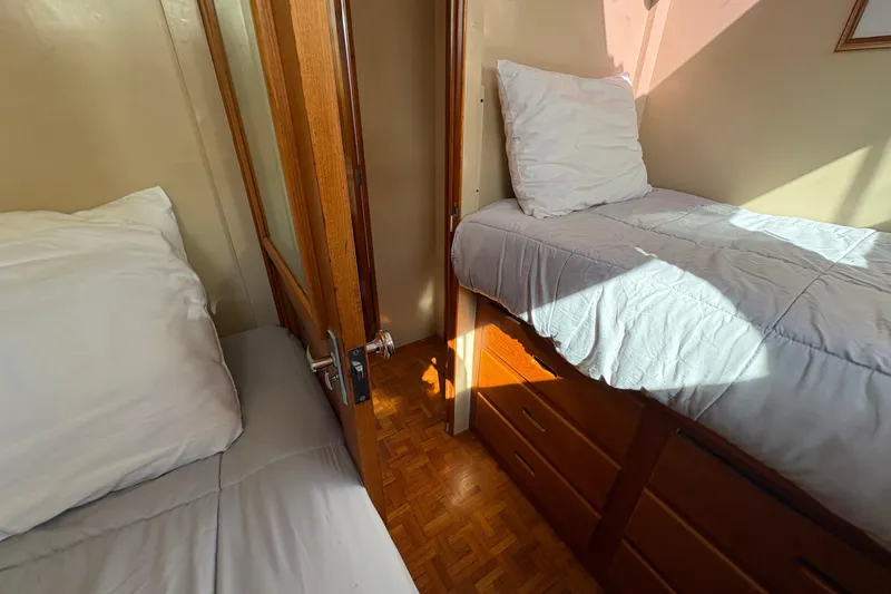 Slide: The Image of Cozy cabin interior of 1984 Grand Banks Classic yacht with twin beds and wooden furnishings. - 52