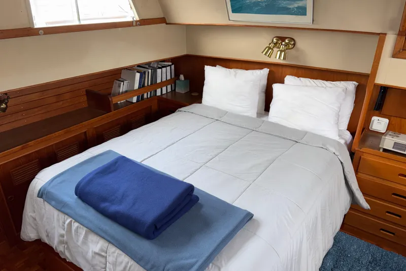 Slide: The Image of Cozy bedroom in 1984 Grand Banks Classic yacht with wooden accents and nautical decor. - 54