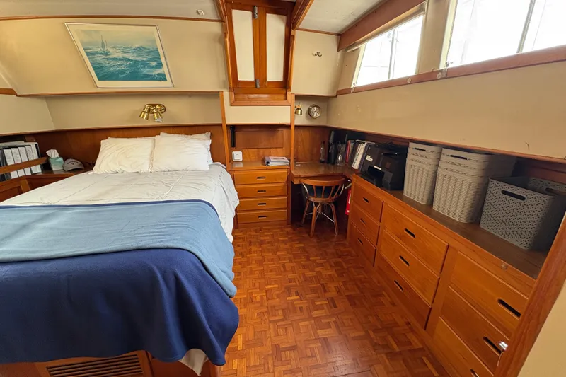 Slide: The Image of 1984 Grand Banks Classic cabin with bed, wooden storage, and nautical decor. - 57