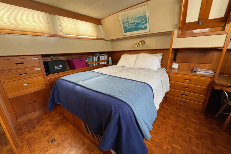Slide: The Image of Cozy bedroom interior of 1984 Grand Banks Classic yacht with wooden furnishings and nautical decor. - 58