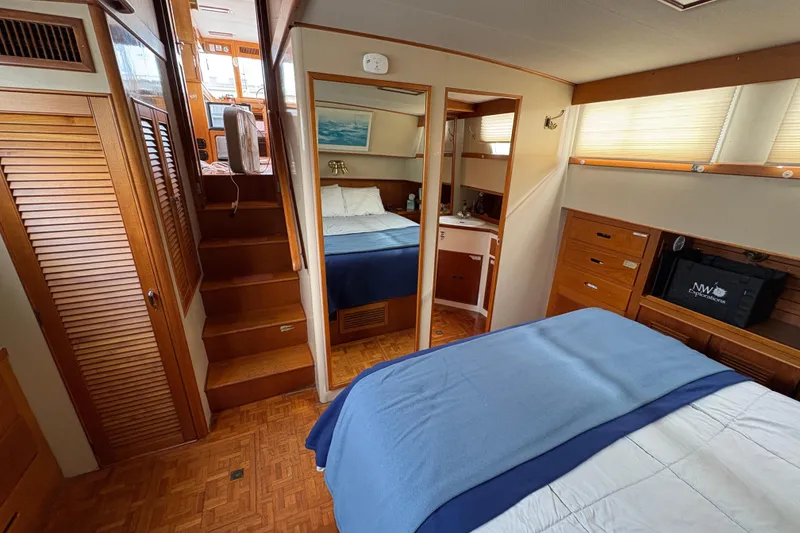Slide: The Image of 1984 Grand Banks Classic yacht interior with wood finishes and cozy bedroom. - 59
