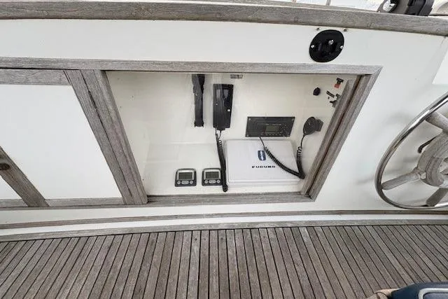 Slide: The Image of 1984 Grand Banks Classic yacht dashboard with navigation equipment and wooden flooring. - 6
