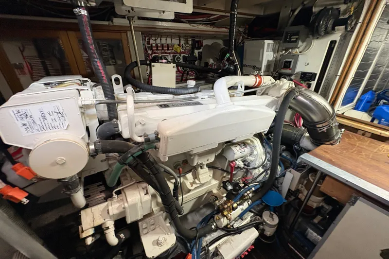 Slide: The Image of Engine room of a 1984 Grand Banks Classic boat, showcasing detailed machinery and components. - 64