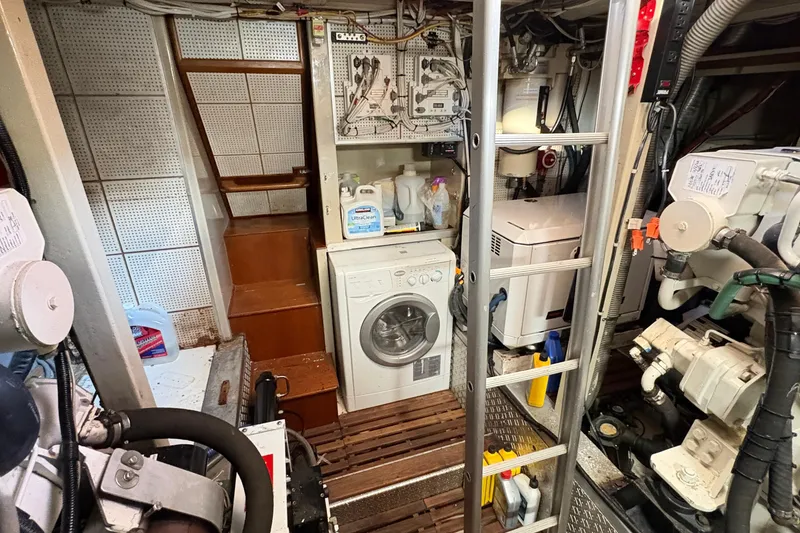 Slide: The Image of Engine room of 1984 Grand Banks 49 Classic yacht, showcasing mechanical components and wiring. - 66