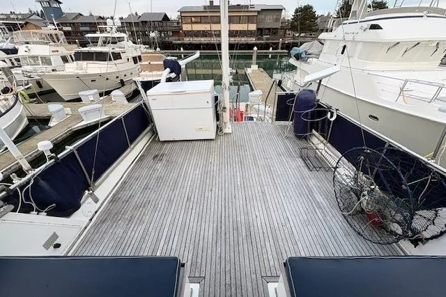 Slide: The Image of 1984 Grand Banks Classic yacht deck at marina, featuring spacious layout and nautical equipment. - 7
