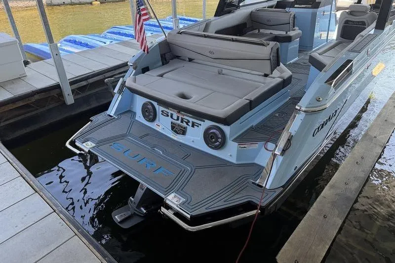 Slide: The Image of 2026 Cobalt R8 Surf boat docked, featuring spacious seating and sleek design. - 14