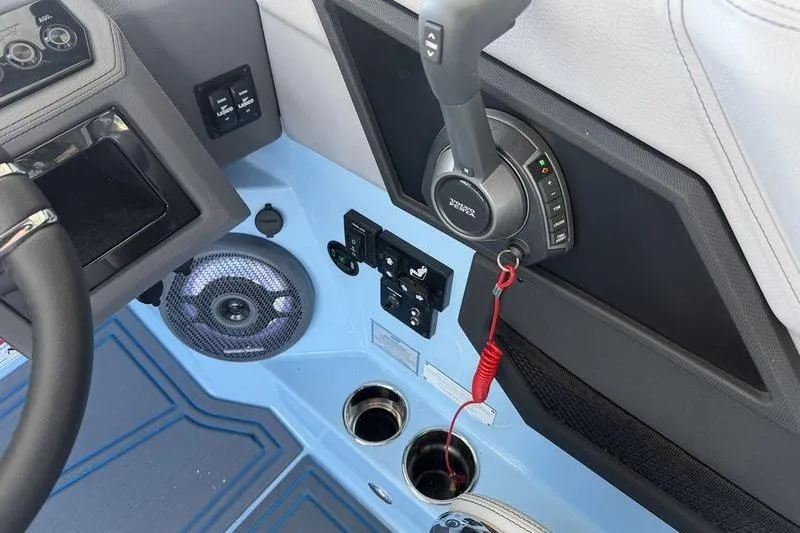 Slide: The Image of 2026 Cobalt R8 Surf boat interior with controls, speaker, and cup holders. - 19