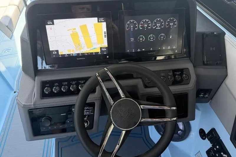 Slide: The Image of 2026 Cobalt R8 Surf boat on a serene lake with wooded shoreline. - 3