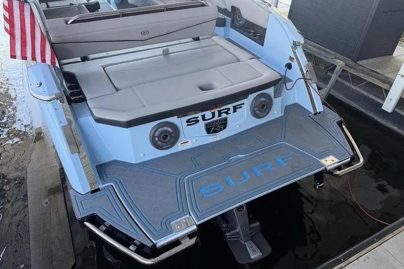 Slide: The Image of 2026 Cobalt R8 Surf boat docked, featuring sleek design and modern amenities. - 5