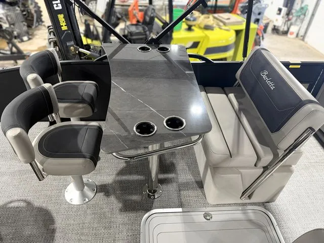 Slide: The Image of Interior of 2026 Barletta Cabrio 24UE 3T with table and seating. - 24