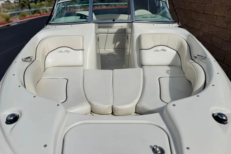 Slide: The Image of 2008 Sea Ray 200 Sundeck boat interior with white seating and logo. - 12