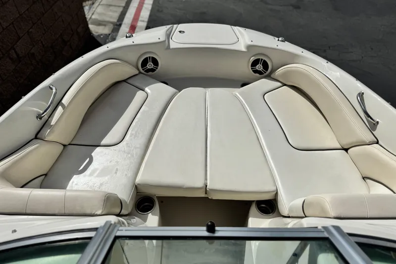 Slide: The Image of 2008 Sea Ray 200 Sundeck boat interior with white cushioned seating. - 13