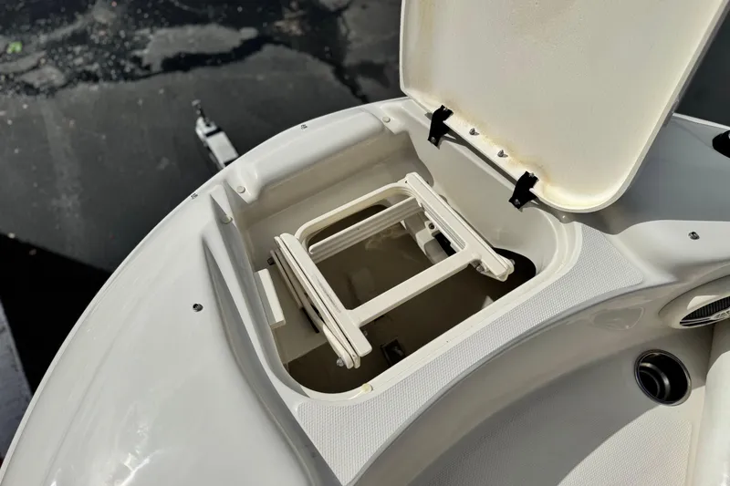 Slide: The Image of Open storage compartment on 2008 Sea Ray 200 Sundeck boat, showing interior details. - 15