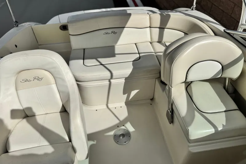 Slide: The Image of 2008 Sea Ray 200 Sundeck interior with white leather seating and logo embroidery. - 17