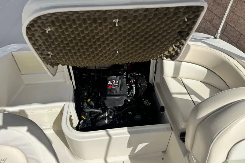 Slide: The Image of 2008 Sea Ray 200 Sundeck engine compartment with open hatch, showcasing interior details. - 19