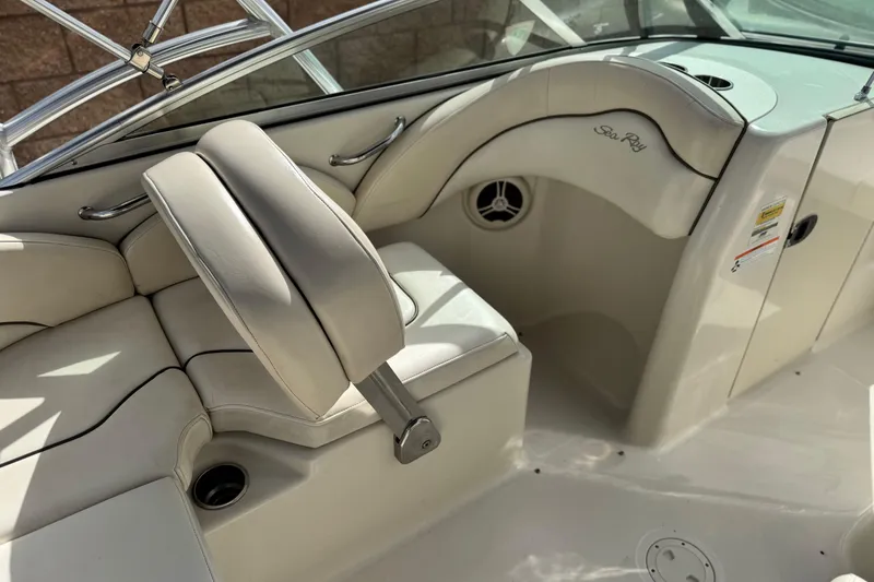 Slide: The Image of 2008 Sea Ray 200 Sundeck interior with beige seating and stainless steel accents. - 21