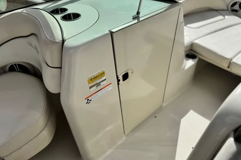 Slide: The Image of 2008 Sea Ray 200 Sundeck interior with seating and storage compartment. - 23