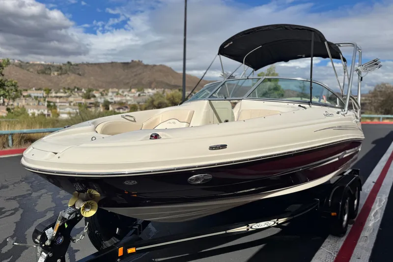 Slide: The Image of 2008 Sea Ray 200 Sundeck boat on trailer, scenic background, sunny day. - 3