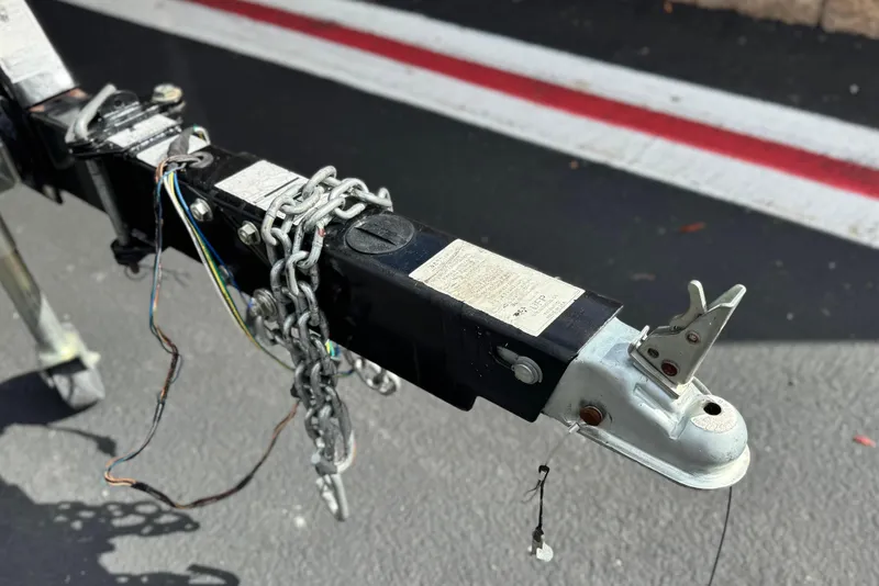 Slide: The Image of Trailer hitch of a 2008 Sea Ray 200 Sundeck with chains and wiring. - 32