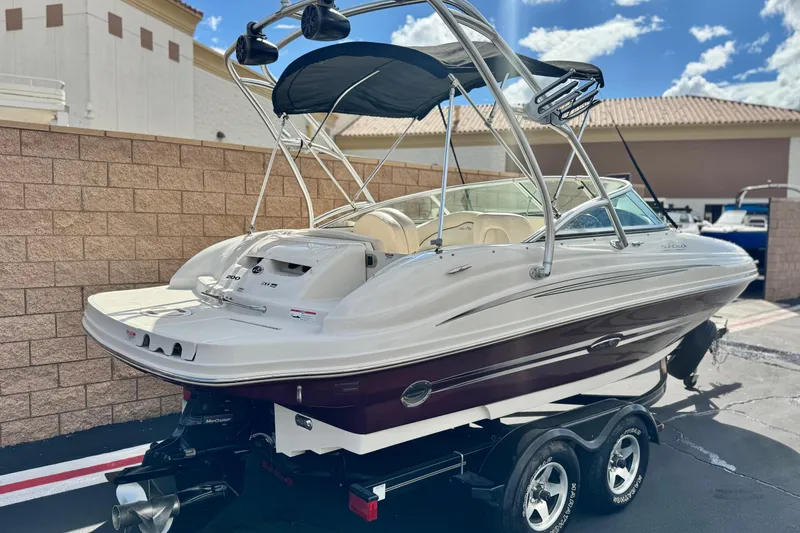 Slide: The Image of 2008 Sea Ray 200 Sundeck boat on trailer, featuring sleek design and bimini top. - 5