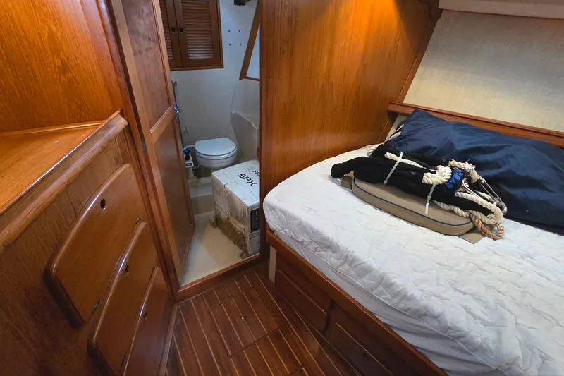 Slide: The Image of Interior of 1989 Island Packet 38 sailboat with wooden cabinetry and compact bathroom. - 10