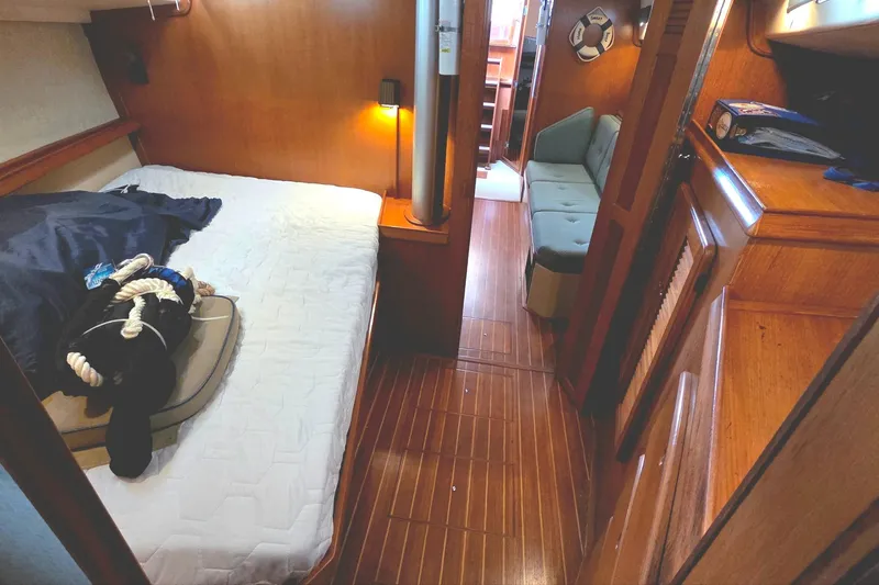 Slide: The Image of 1989 Island Packet 38 interior with cozy cabin, wooden flooring, and nautical decor. - 11