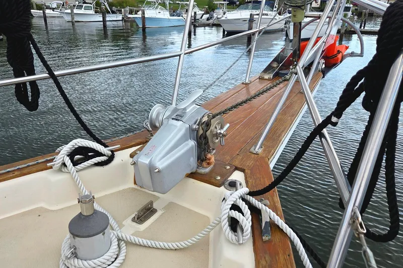 Slide: The Image of 1989 Island Packet 38 sailboat deck with winch and ropes at marina. - 17