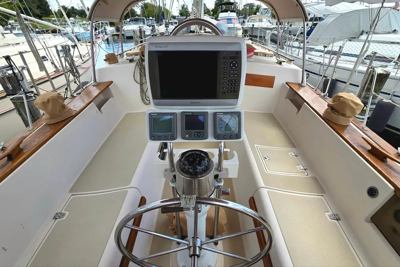 Slide: The Image of Cockpit of 1989 Island Packet 38 sailboat with navigation equipment and steering wheel. - 2