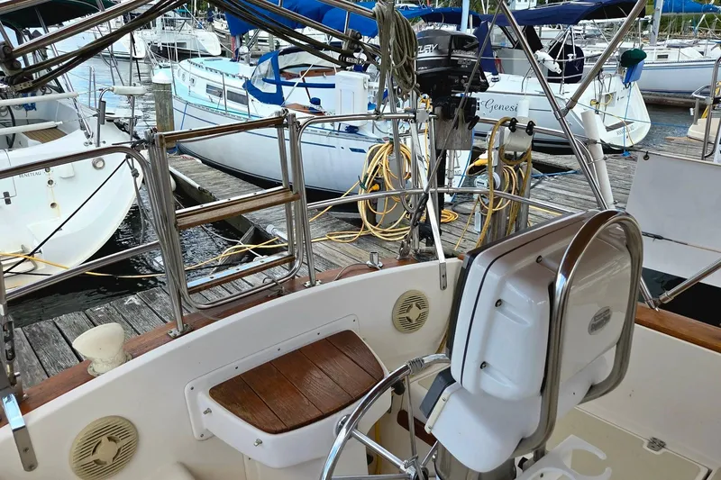 Slide: The Image of Cockpit view of 1989 Island Packet 38 sailboat docked at marina with other boats. - 4