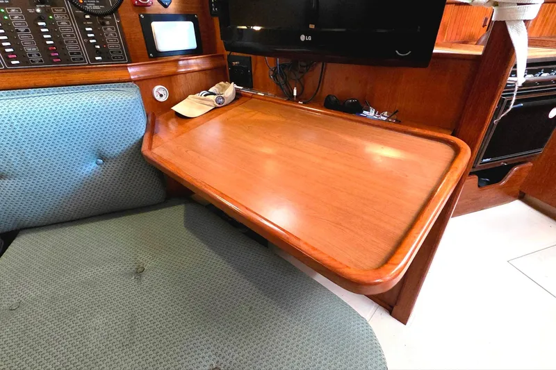 Slide: The Image of 1989 Island Packet 38 interior with wooden desk and cushioned seating. - 8