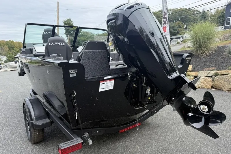 Slide: The Image of 2026 Lund 1650 Rebel SS boat interior with gray seating and dashboard. - 13