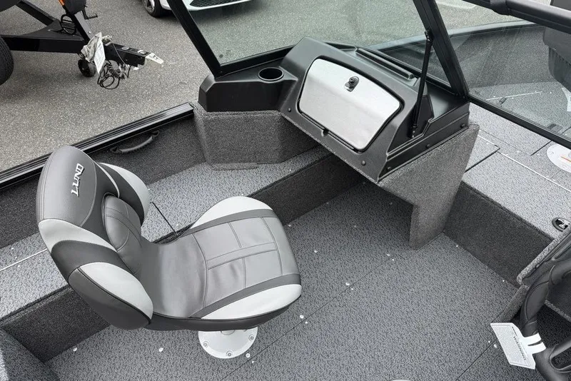 Slide: The Image of 2026 Lund 1650 Rebel SS boat interior with steering wheel and control panel. - 14