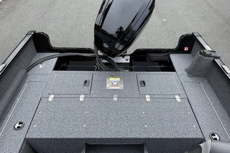 Slide: The Image of 2026 Lund 1650 Rebel SS boat interior with motor and storage compartments. - 5