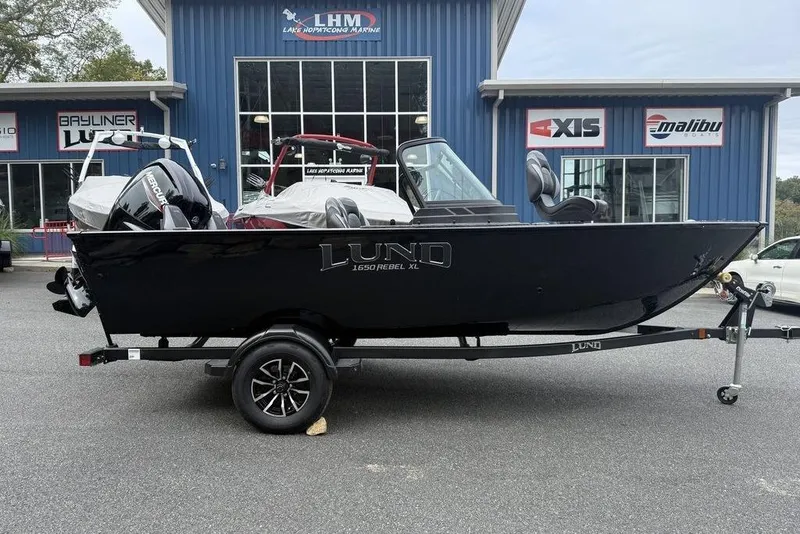 Slide: The Image of 2026 Lund 1650 Rebel SS boat interior with dual seats and motor. - 6