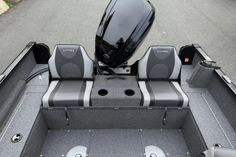 Slide: The Image of 2026 Lund 1650 Rebel SS boat interior with swivel seat and storage compartments. - 7