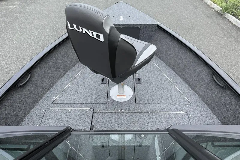 Slide: The Image of 2026 Lund 1650 Rebel SS boat interior with storage compartments and fishing net. - 8