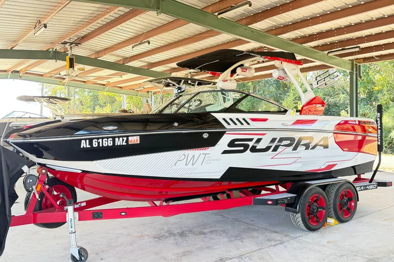 The Image of 2017 Supra SA450 boat on trailer in covered storage area. - 0