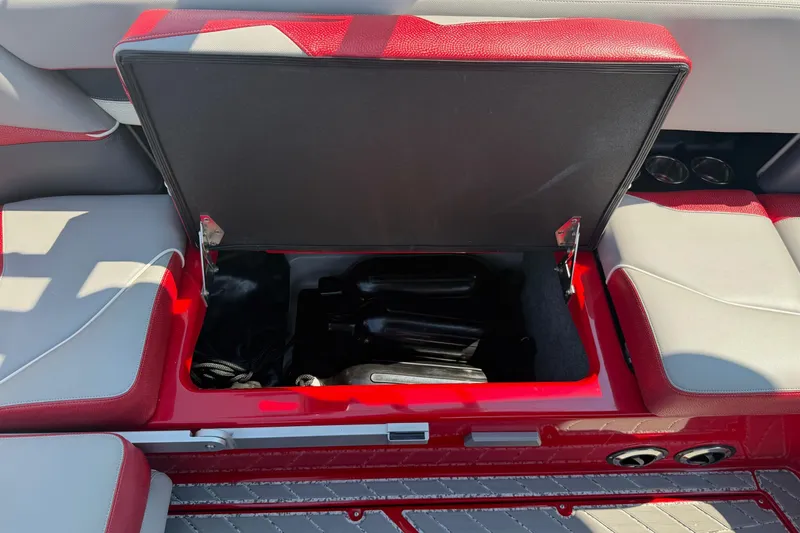 Slide: The Image of Interior of a 2017 Supra SA450 boat with red and gray seating. - 11