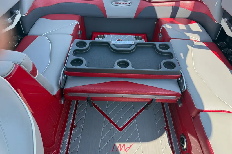 Slide: The Image of 2017 Supra SA450 boat interior with red and gray seating, under a metal canopy. - 12