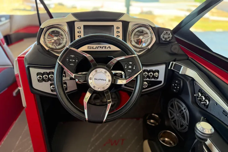 Slide: The Image of 2017 Supra SA450 boat dashboard with steering wheel and control panel. - 16